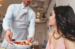 smiling-waiter-serving-food-to-charming-lady-2025-03-09-07-08-27-utc